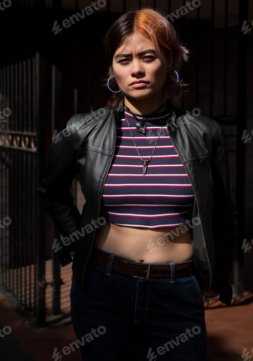 Preview: Young urban woman looking at camera with attitude.