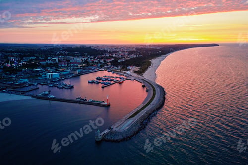 Preview: Harbor with ship sailing to port during sunset