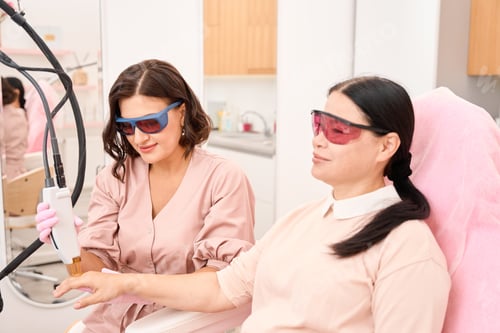 Preview: Client of cosmetology clinic undergoing laser hair removal procedure for fingers