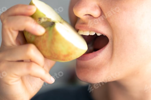 Preview: Detailed shot of a woman eats piece of fresh apple.