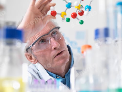 Preview: Scientist viewing molecular model of a chemical formula in a laboratory