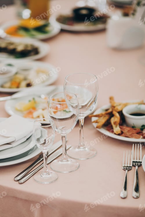 Preview: Wedding setting, tender pink table with glasses, cutlery, napkin and delicious food and drinks
