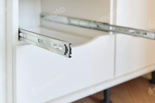 Preview: Furniture details close-up, installation of drawers in the cabinet
