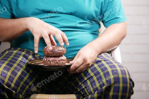 Preview: young man eating donut , selective focus