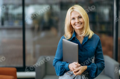 Preview: Professional Woman Holding Laptop in Modern Office
