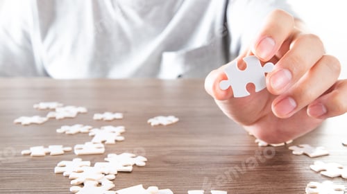 Preview: Closeup hand of man holding parts jigsaw puzzle. Business solutions and strategy concept