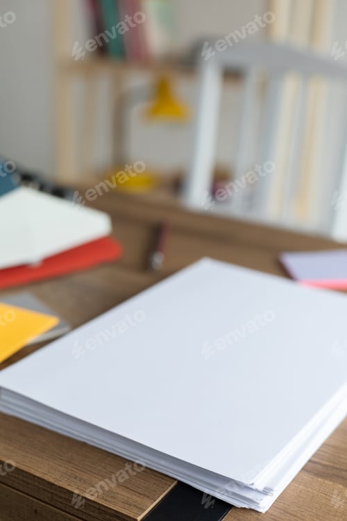 Preview: Sheet of paper on wood desk table. Office or study creative concept