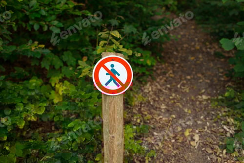Preview: A round sign prohibiting entry into the forest. Shows a crossed-out person. The sign is in focus on