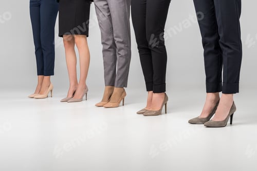 Preview: cropped view of women standing in hight heel shoes on grey background