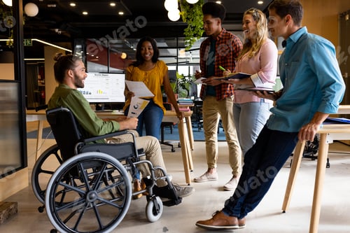 Preview: Diverse male and female colleagues in discussion at casual office meeting