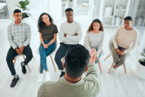 Preview: Shot of an unrecognisable man standing and talking to his support group