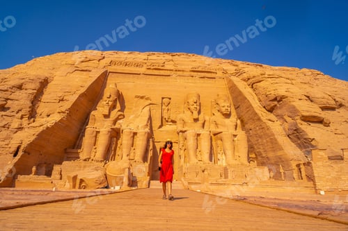 Preview: A European Tourist In Red Dress At The Abu Simbel Temple In Southern Egypt In Nubia Next To Lake