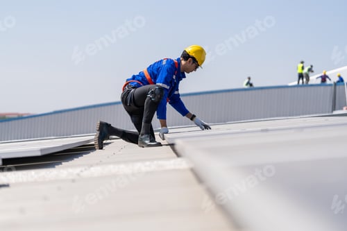 Preview: Engineer service check installation solar cell on the roof of factory.