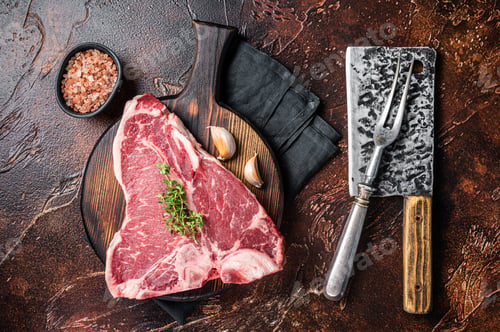 Preview: Raw Porterhouse steak, marbled beef meat on a wooden board. Dark background. Top view