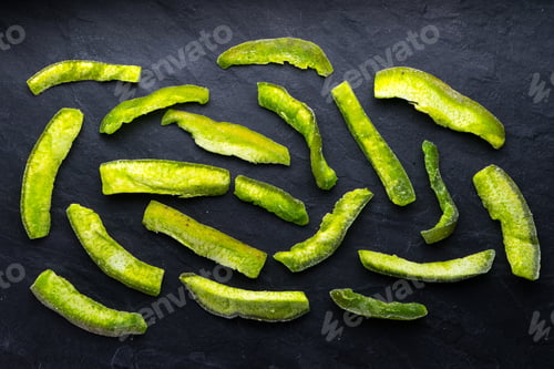 Preview: Bright green pieces of pomelo on a blue stone