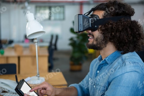 Preview: Graphic designer using the virtual reality headset and digital tablet