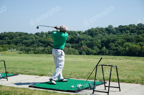 Preview: Golfer Swinging Club on a Sunny Day