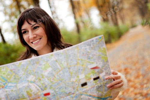 Preview: Woman Sightseeing Outdoors And Holding A Map