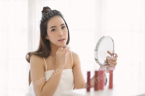 Preview: Beautiful Asian woman fresh healthy skin using moisturizing face cream, cosmetic in bedroom.