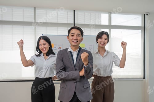 Preview: Portrait of smiling group Asian professional confident business people team standing and looking at