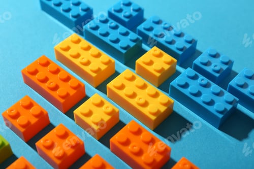 Preview: Construction toy. Colorful building bricks on light blue background, closeup