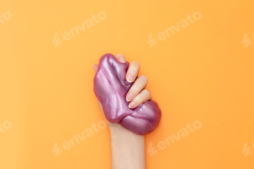 Preview: Violet slime in hand on orange.