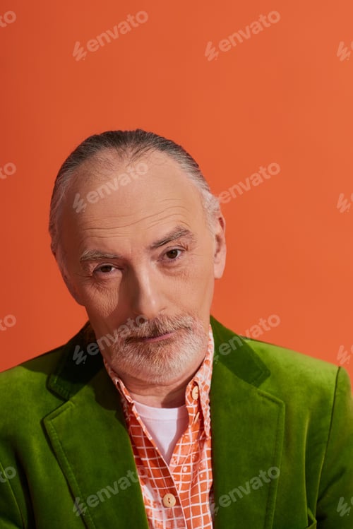 Preview: portrait of skeptical and thoughtful grey haired, bearded senior man wearing green velour blazer