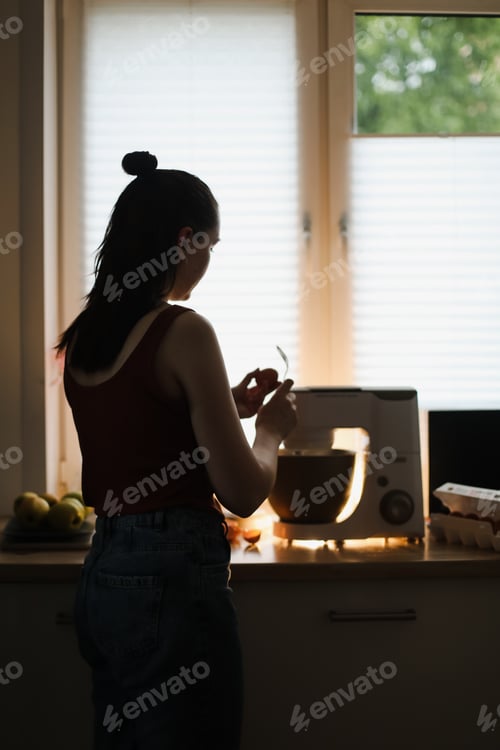 Preview: Woman baking at home using kitchen planetary mixer