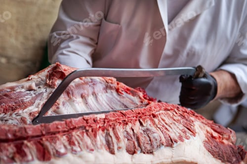 Preview: The butcher work at the chopping block in his shop