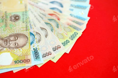 Preview: Close-up of Vietnamese Dong Currency on Red Surface