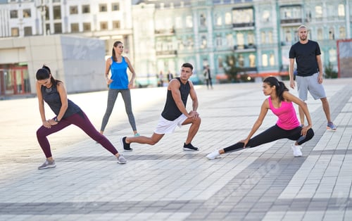 Preview: Athletic people warming up before jogging in the street