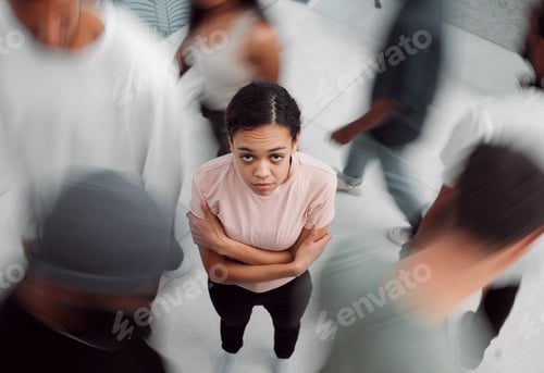 Preview: Shot of a young woman experiencing mental illness while being surrounded by people inside
