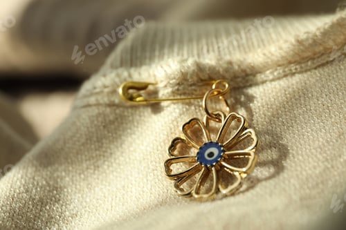 Preview: Evil eye safety pin on clothing, closeup