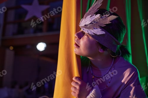 Preview: Girl in Costume Peeking from behind Curtains during Play at Childrens Theater