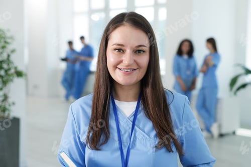 Preview: Medical student in uniform with notebook indoors, selective focus