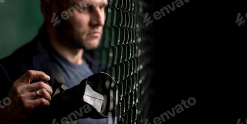 Preview: Portrait of young stylish male photographer with his professional camera at wire