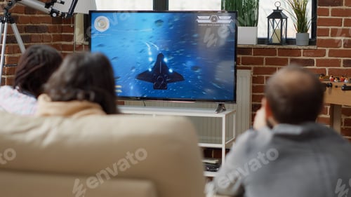 Preview: Cheerful people playing shooting video games on television
