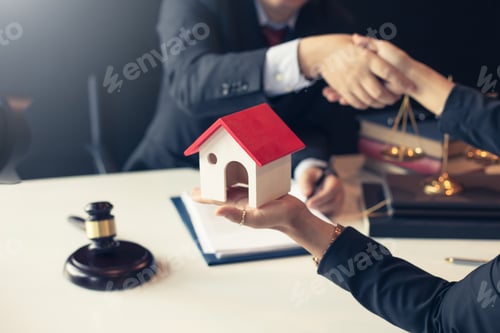 Preview: Businessman and lawyer shaking hands. Buy - sell house.