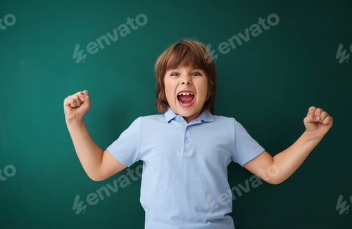 Preview: Back to school. Boy near green chalkboard indoors
