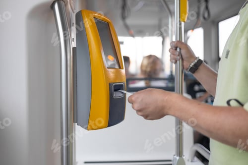 Preview: Yellow ticket validation machine on a modern public transport bus. Traveler validating train ticket
