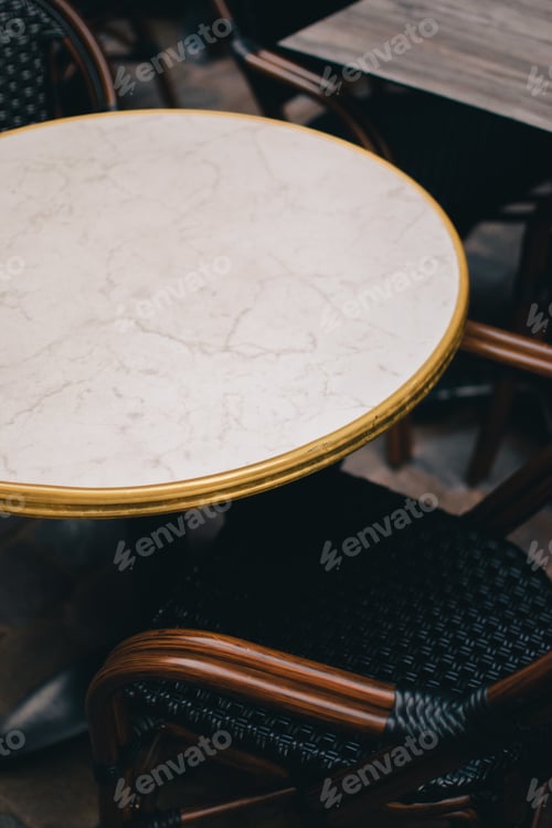 Preview: a small table and two chairs on the floor near the window