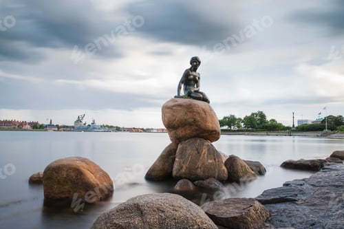 Preview: Serene statue overlooking calm waters