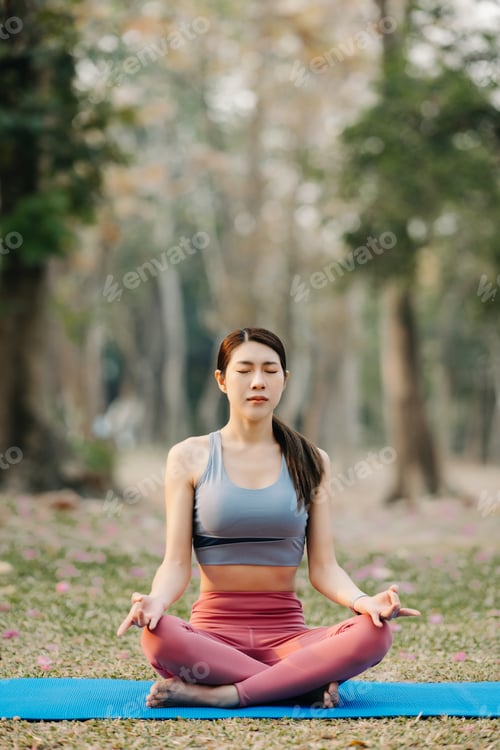 Preview: Portrait of young woman practicing yoga in garden.female happiness. in the park blurred