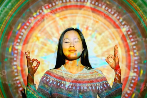 Preview: Asian woman meditating near mandala