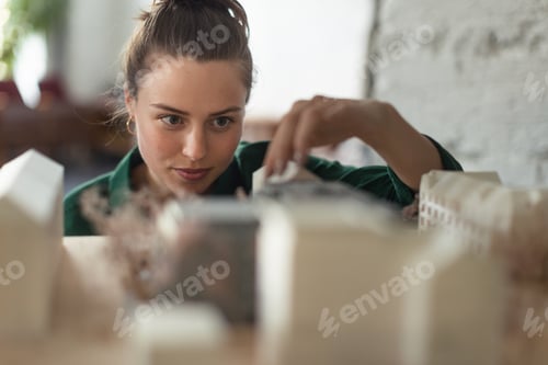 Preview: Young female architect hard working on design of new house, building.