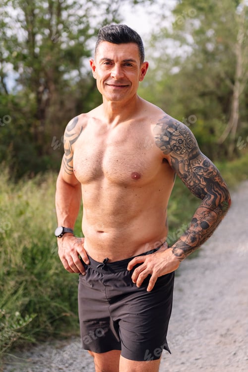 Preview: man with fitness body smiling in the countryside