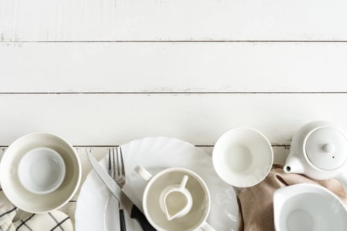 Preview: White empty dishes on wooden table with copy space