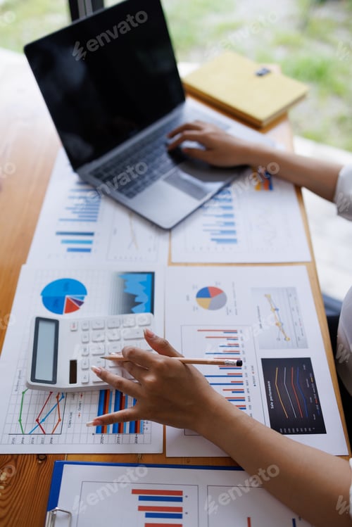 Preview: Close up of businesswoman Accounting using calculating income-expenditure and analyzing real estate