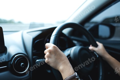 Preview: Closeup image of a woman holding steering wheel while driving a car