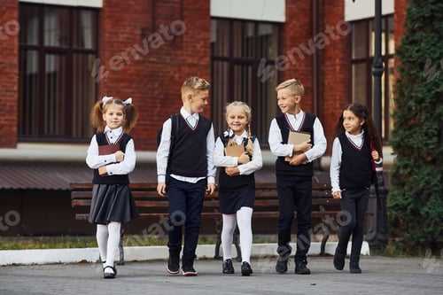 Preview: Group of kids in school uniform that is outdoors together near education building